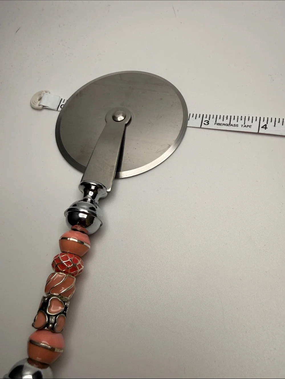Decorative Coral-Peach Beaded Pizza Cutter with Chrome Handle